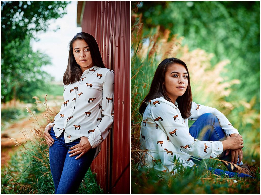 senior girl posing next to barn